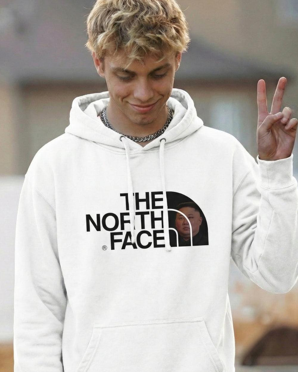 Person wearing a white 'The North Face' hoodie outdoors